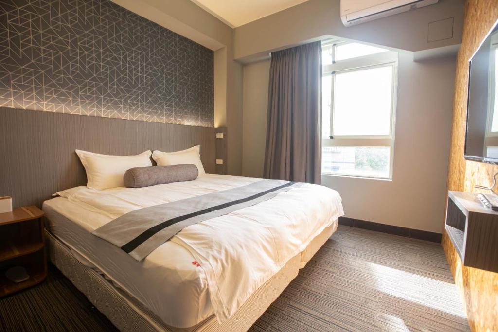 Postel nebo postele na pokoji v ubytování 雅舍 Arthur Hostel