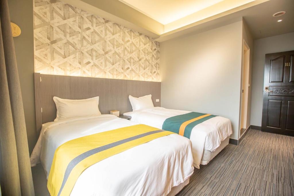 Postel nebo postele na pokoji v ubytování 雅舍 Arthur Hostel