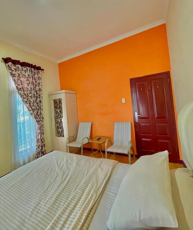 Postel nebo postele na pokoji v ubytování Sapo Karo Rest House