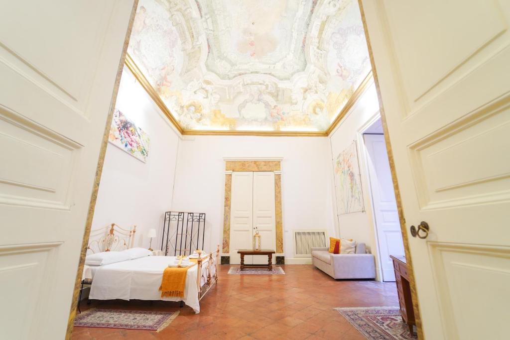 a room with a bed and a ceiling at Casa Napoletana - Culture Apartment in Naples