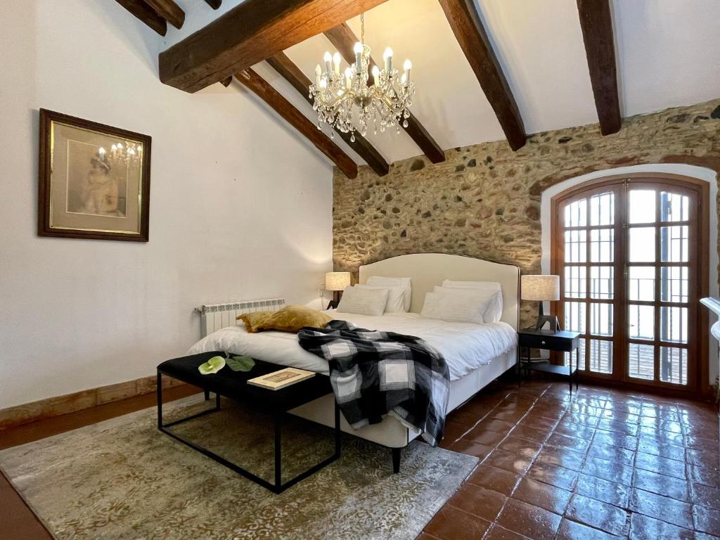 a bedroom with a bed and a chandelier at Barri Antic Cambrils in Cambrils