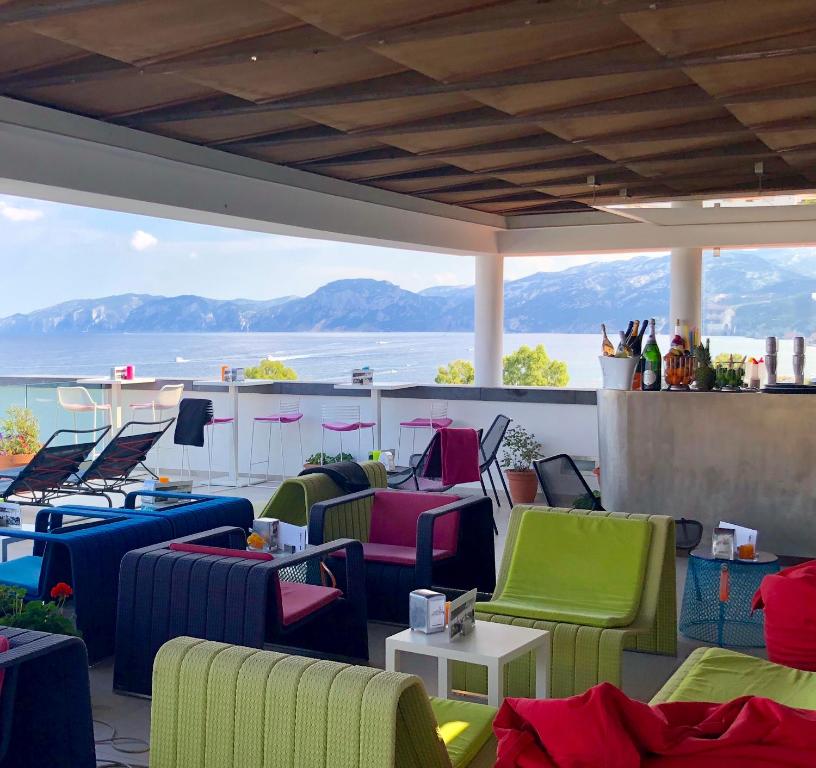 a group of chairs and tables on a balcony at Hotel Cala Luna in Cala Gonone