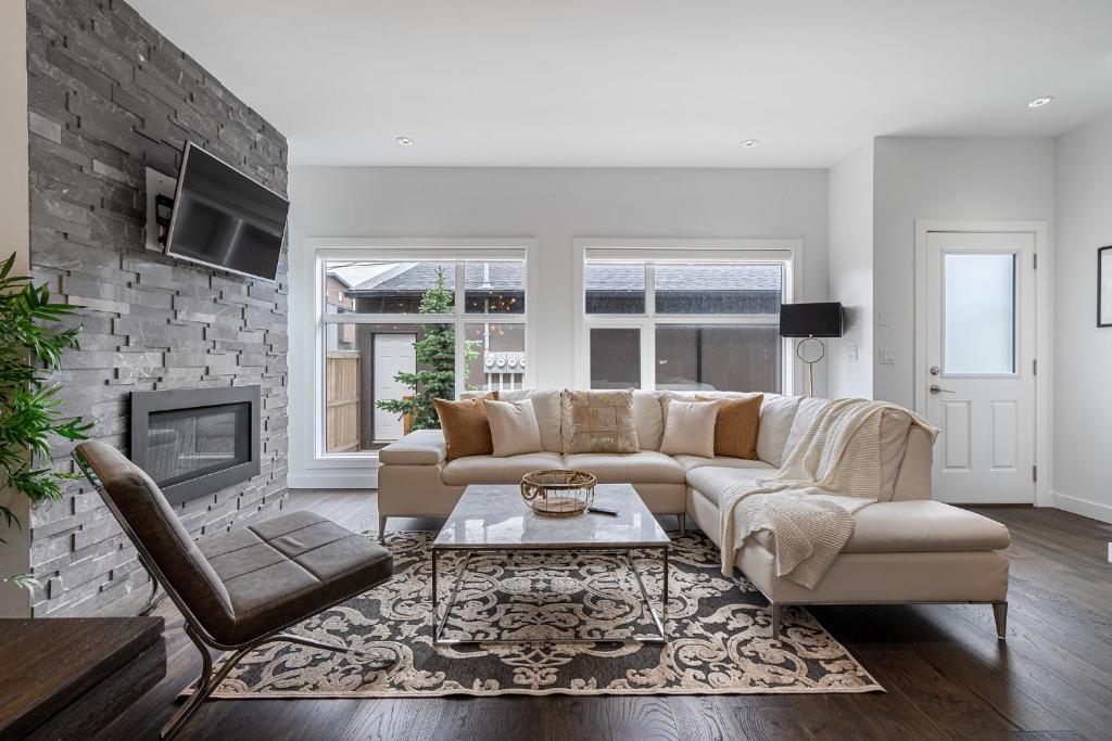 a living room with a couch and a fireplace at Contemporary Luxury 4 bedroom House near Downtown in Calgary