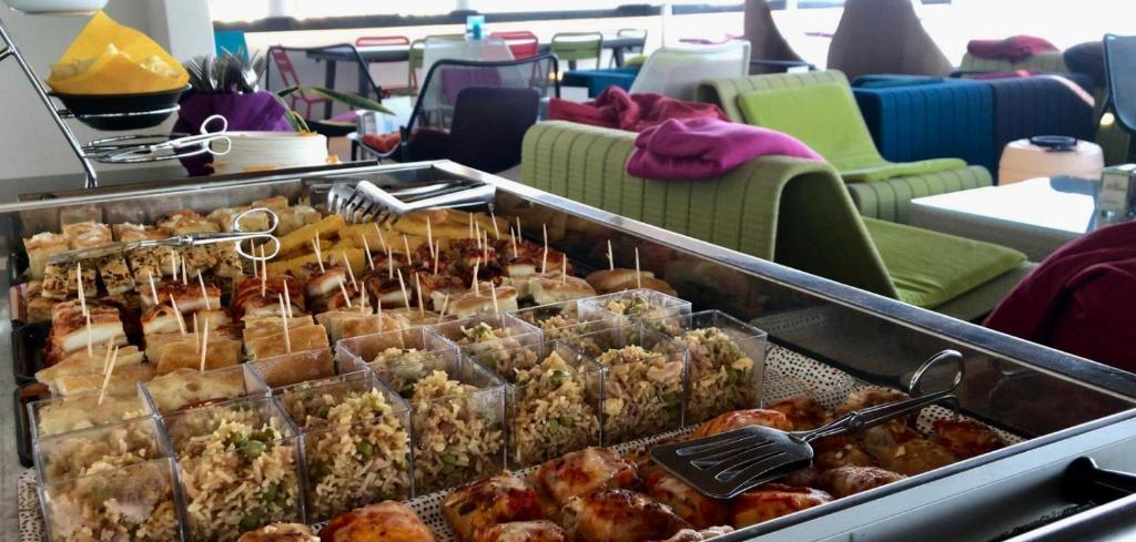 a display of pastries in trays on a bus at Hotel Cala Luna in Cala Gonone