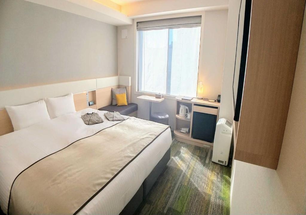 Postel nebo postele na pokoji v ubytování Urban Hotel Kyoto Gojo Premium