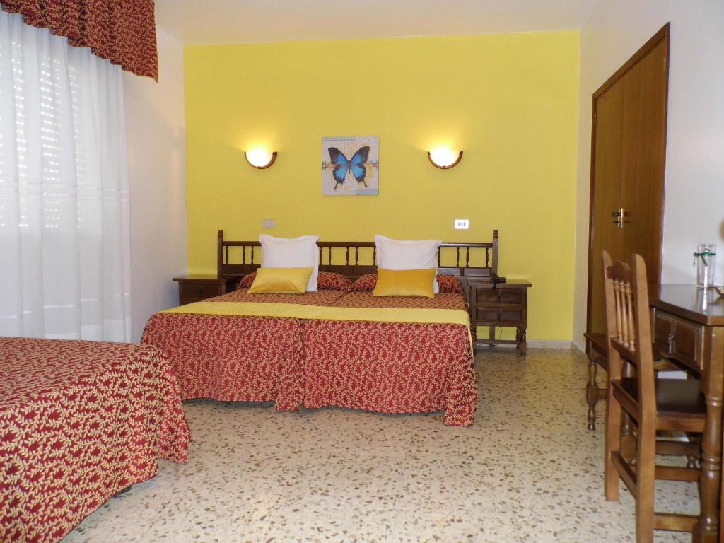 Postel nebo postele na pokoji v ubytování Hotel Arboleda