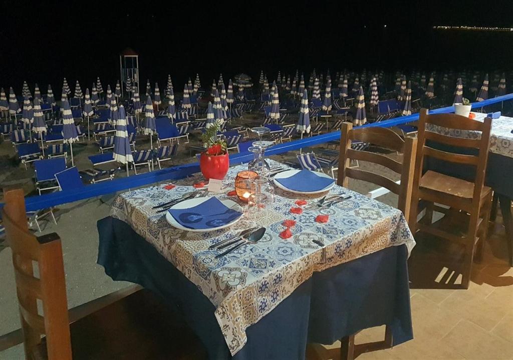 a table with a blue and white table cloth and chairs at Ahm7nani in Mascali