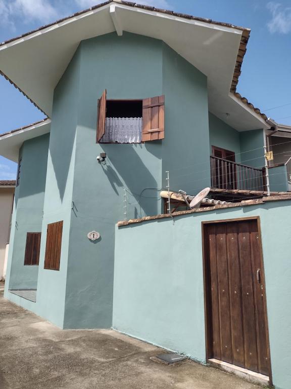 a blue house with a door and a balcony at Casa Paraty in Paraty