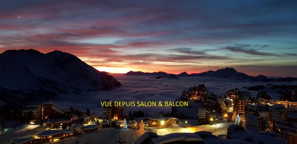 a view of a city at night with the mountains at F2 résidence Antarès in Avoriaz