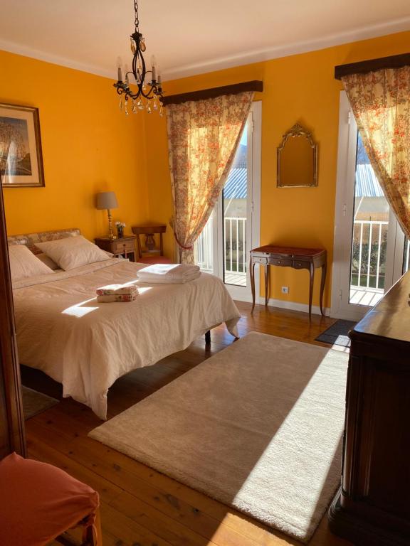 a bedroom with two beds and yellow walls at Chez Hélène 3 étoiles, labellisé disabled PMR,pour 4 personnes chiens bienvenus-pet friendly in Bourg-Madame