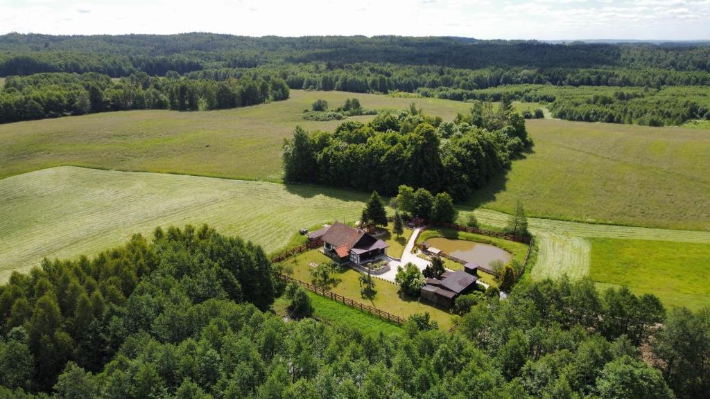 an aerial view of a house in the middle of a field at OAZA SPOKOJU NA FERMIE JELENI SLOW LIFE APARTAMENTy in Górowo Iławeckie