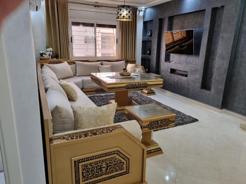 a living room with a white couch and a fireplace at Nador Khattabi 2-18 in Nador