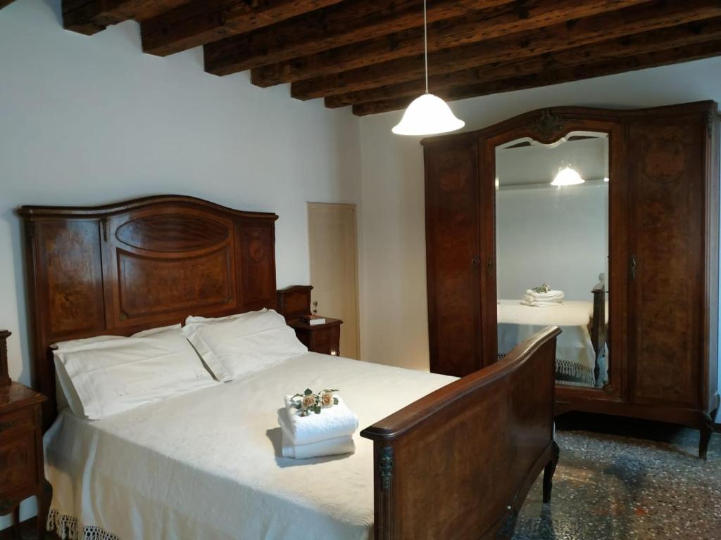 a bedroom with a large bed and a large mirror at Ca Marga Cannaregio - Central Venetian Style 2 bedroom apartment in Venice