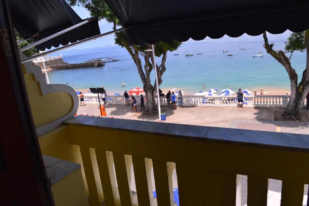 a balcony with a view of a beach and the ocean at Beach Front Village in Salvador