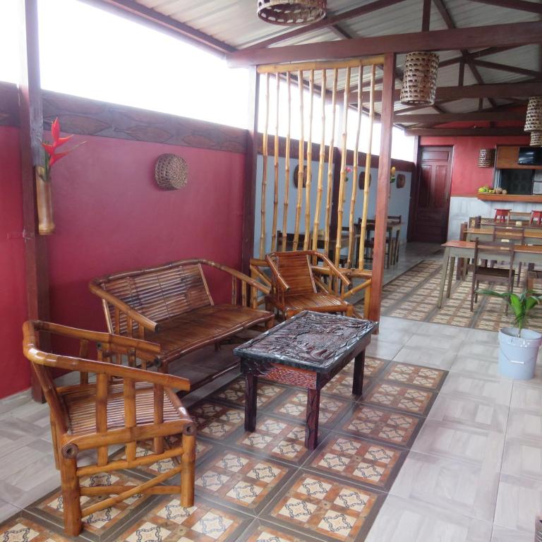 a group of chairs and a table in a room at Micaval Residential in São Tomé