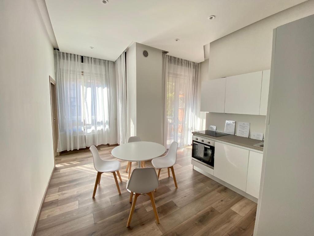 a kitchen with a table and chairs in a room at Suite boutique Moscova in Milan