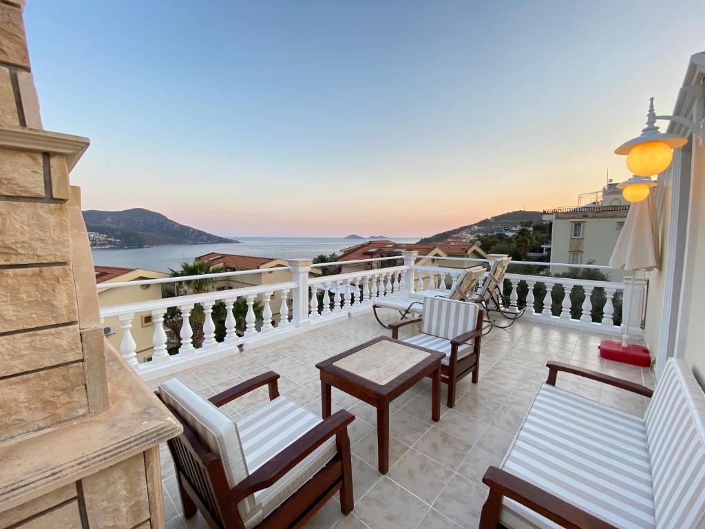 a balcony with chairs and a view of the ocean at Villa Diana in Kalkan