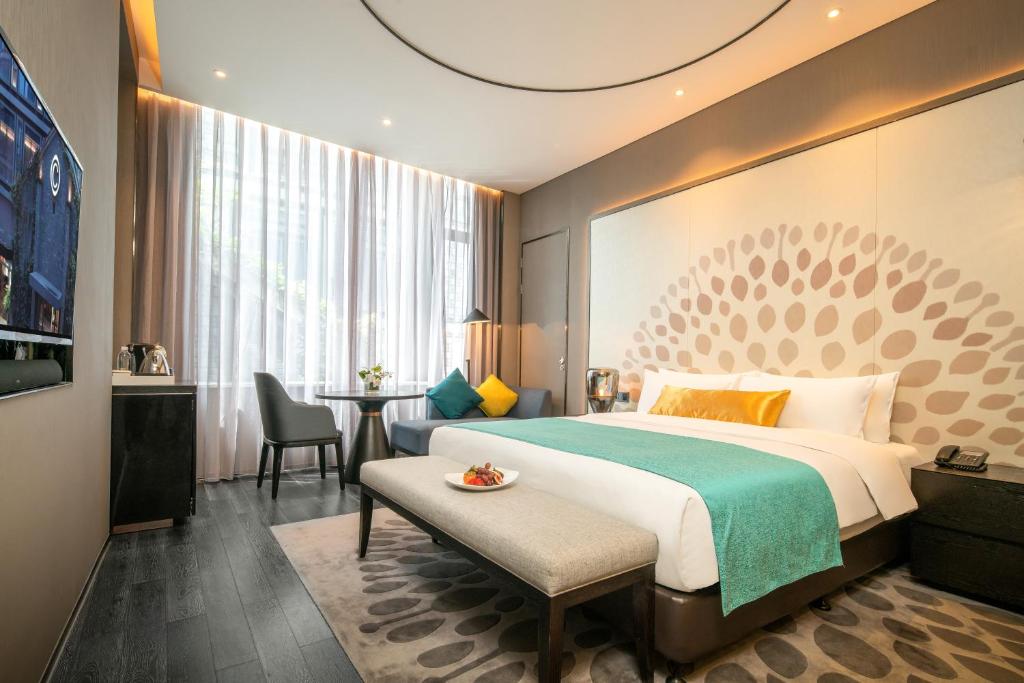 Postel nebo postele na pokoji v ubytování Cachet Boutique Kunming Artime