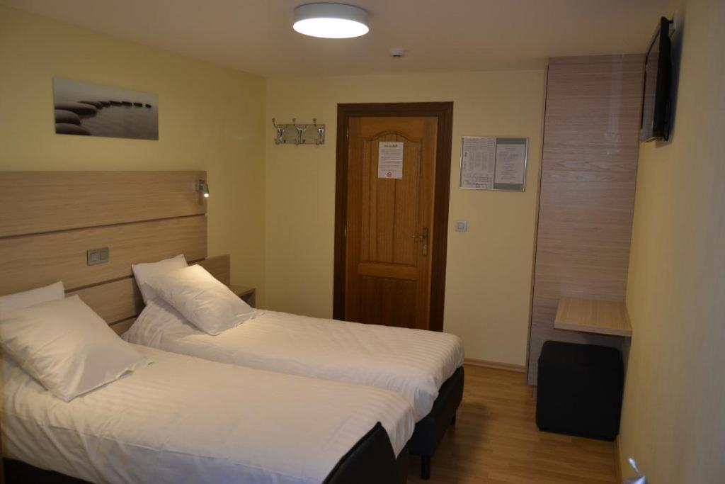 Postel nebo postele na pokoji v ubytování Hotel Beau Site