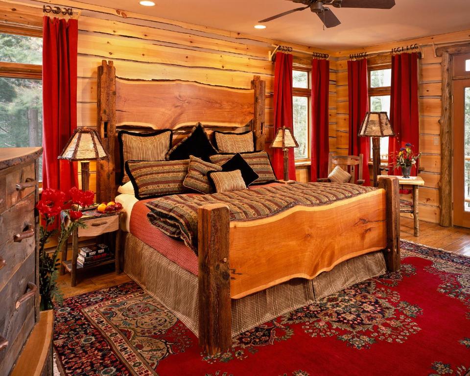 a bedroom with a large wooden bed in a room at The Fern Lodge in Chestertown