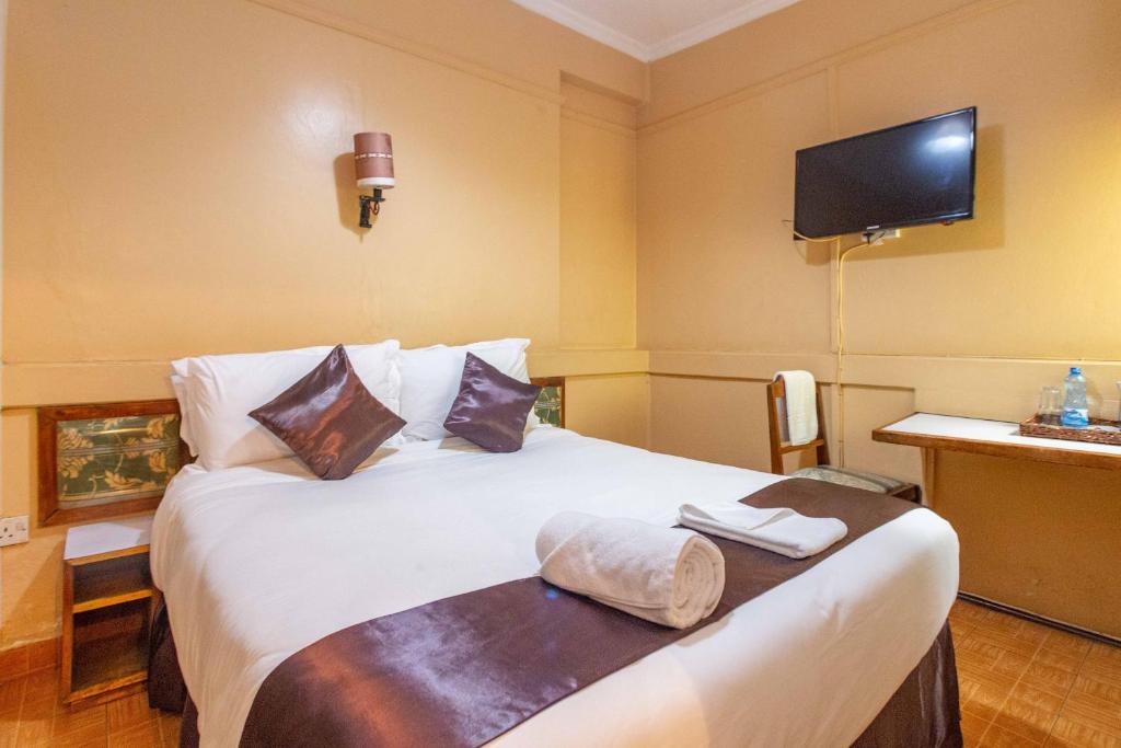 Postel nebo postele na pokoji v ubytování Impala Hotel Parklands