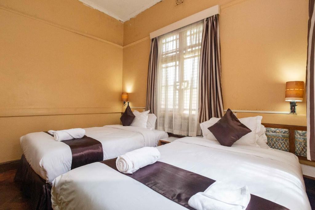 Postel nebo postele na pokoji v ubytování Impala Hotel Parklands