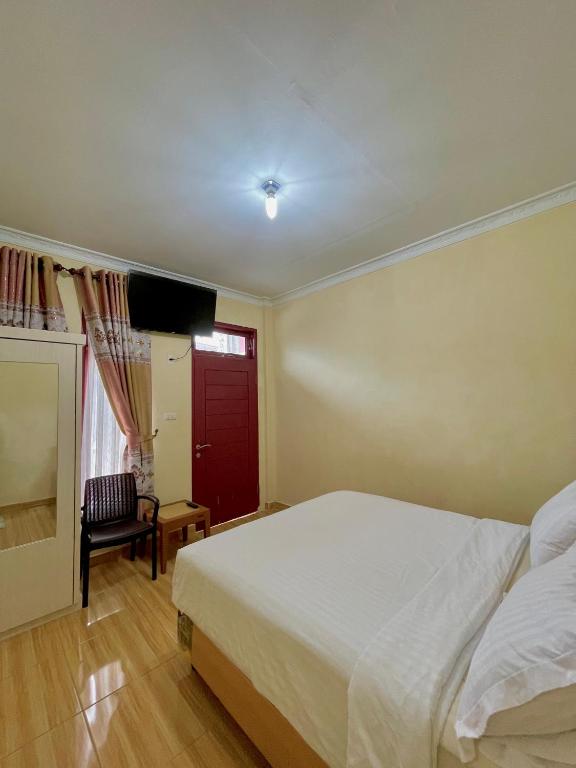 Postel nebo postele na pokoji v ubytování Sapo Karo Rest House