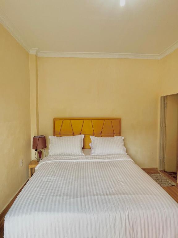Postel nebo postele na pokoji v ubytování Sapo Karo Rest House