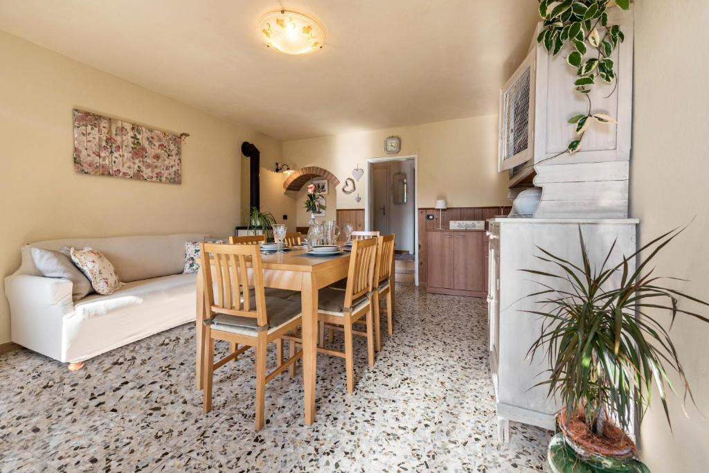 a kitchen and living room with a table and chairs at Casa Vacanze Voiandes in Tremosine Sul Garda