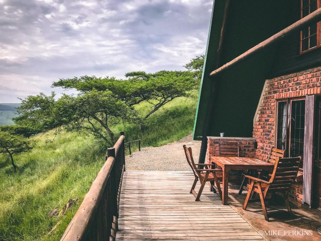a wooden deck with a table and chairs on a building at Bonnie View Game Lodge in Hilton