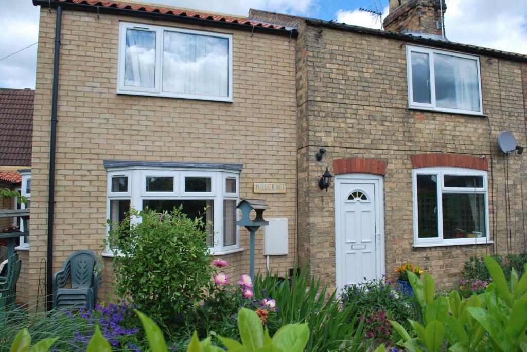 a brick house with a white door and windows at Hillcroft Luxury Bed & Breakfast in Fangfoss