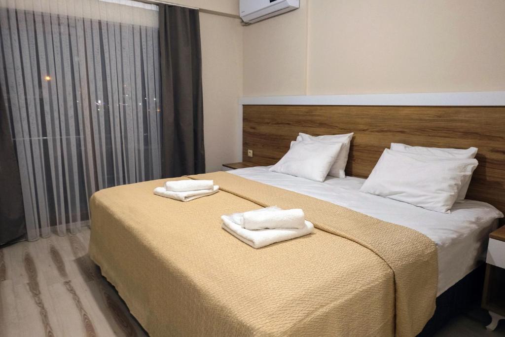 a hotel room with a bed with towels on it at Siba Pamukkale Life in Denizli