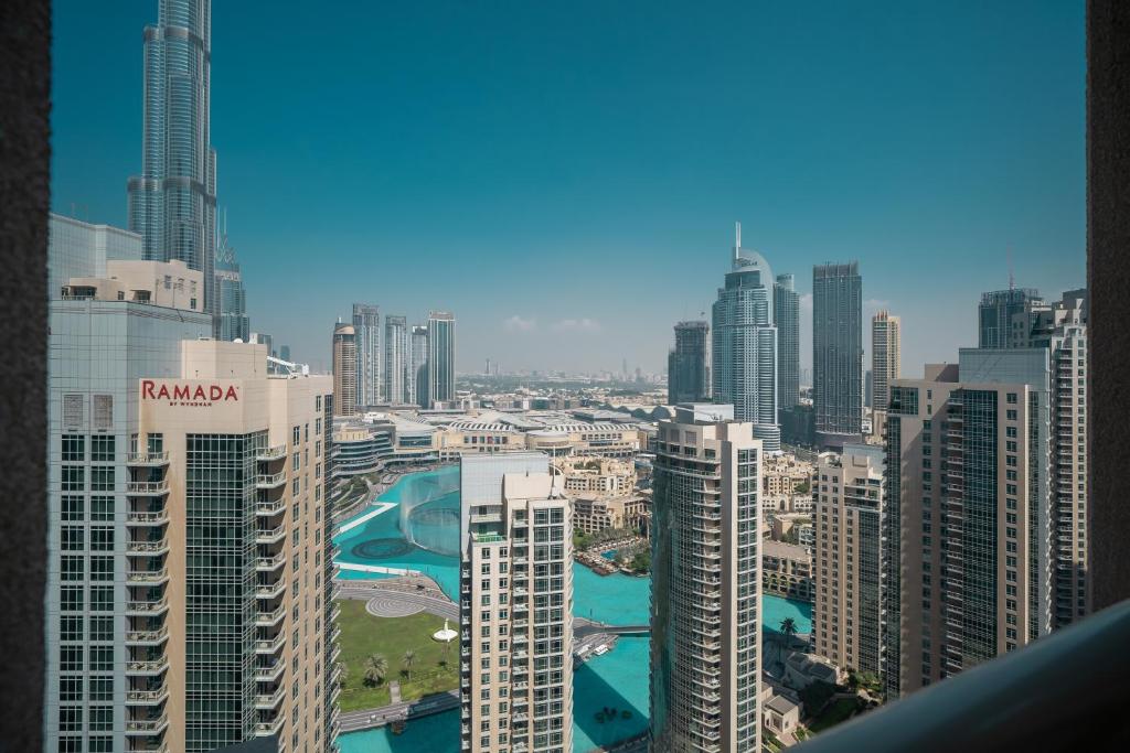 a view of a city with tall buildings at BellaVista - Sophisticated - 2 BR - 29 Boulevard - Burj Khalifa & Fountain View in Dubai