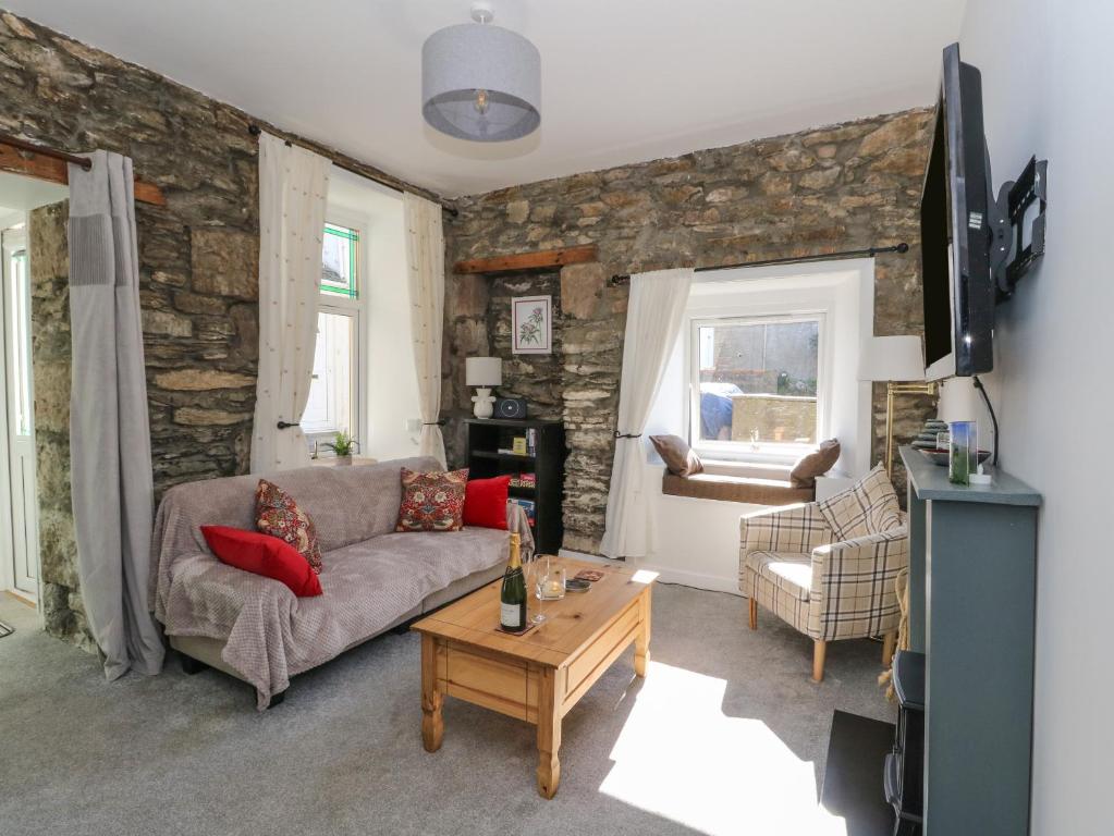 a living room with a couch and a table at The Coorie Cove in Helensburgh