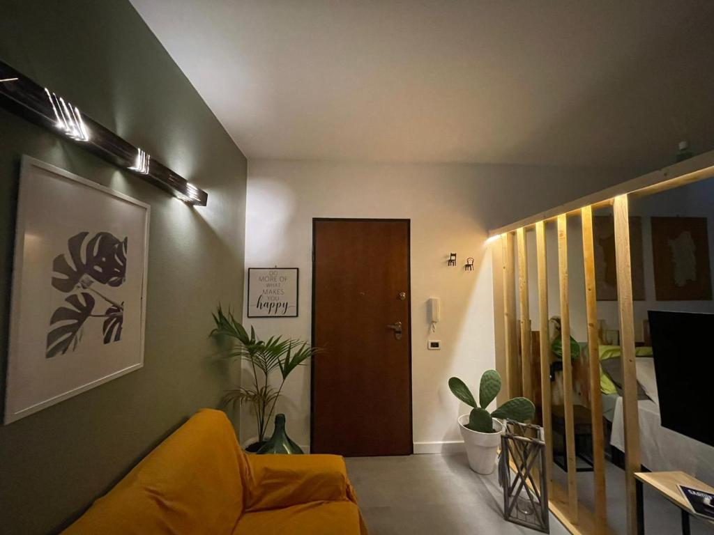 a living room with a yellow couch and a door at Casa Lilla&Fabry Olbia in Olbia