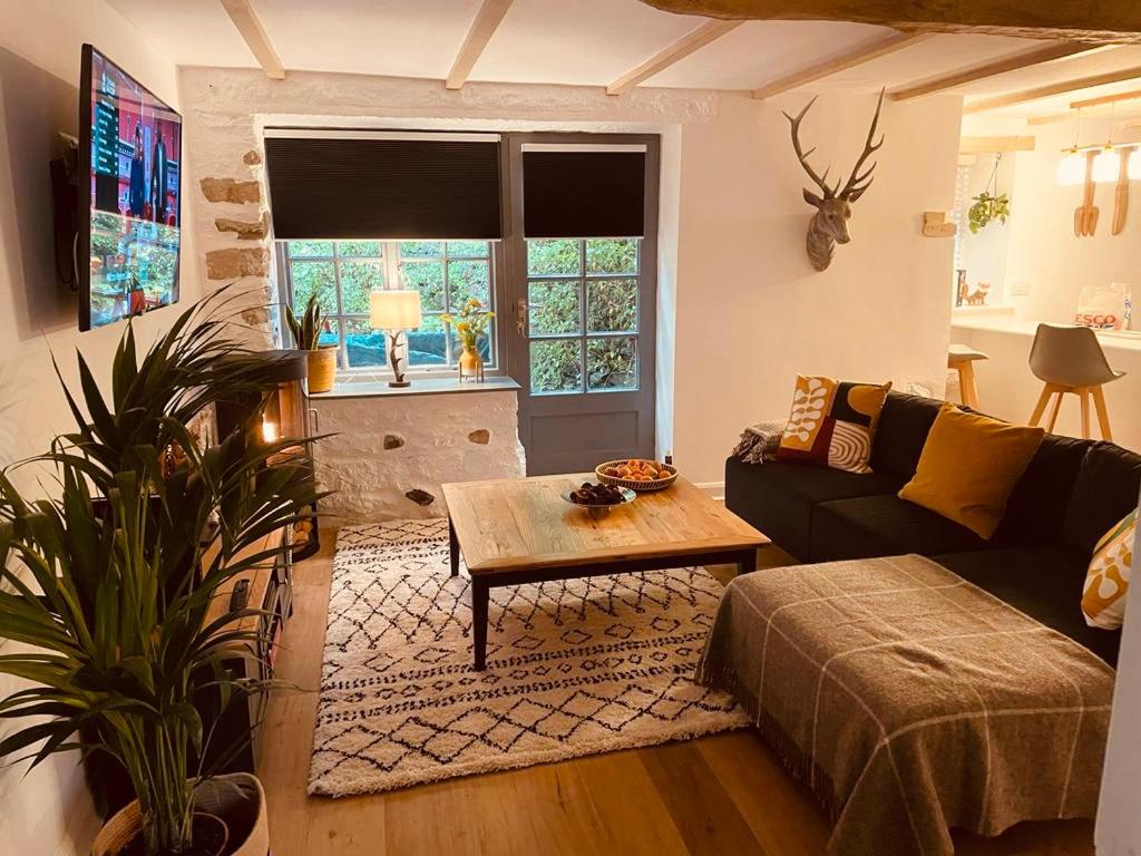 a living room with a couch and a table at Little Wren Cartmel Couples Retreat in Cartmel