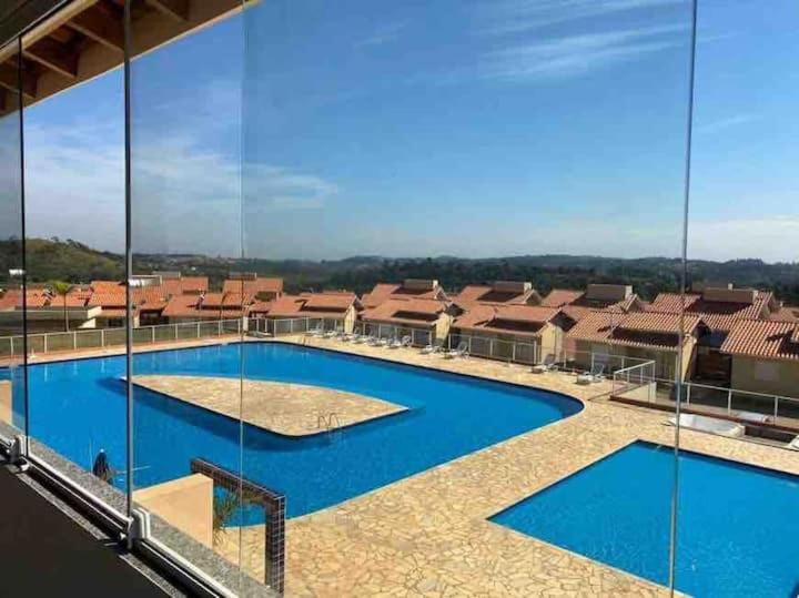 an image of a swimming pool on a building at Catarina Chalé - Cond Clube in Mairinque