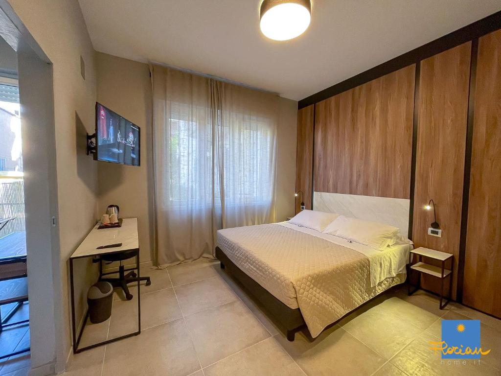 a bedroom with a bed and a desk in it at Florian Home in Pescara
