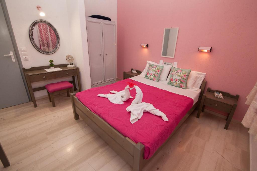 a bedroom with a bed with a dog laying on it at Vasilakis Studios & Apartments in Stalís