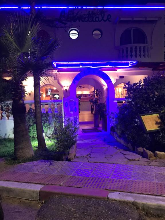 a building with purple lights on it at night at Hotel L'Initiale in Oualidia