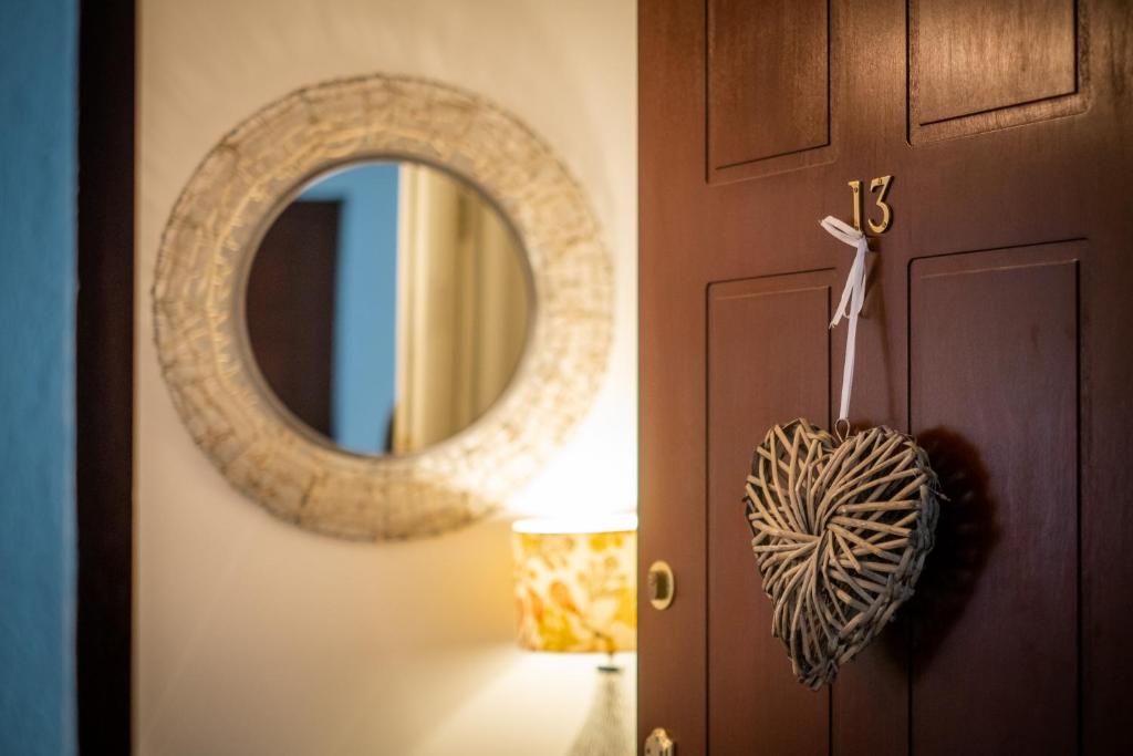 a door with a mirror next to a lamp at Bellman apartment - Pet friendly with parking - FREE off-site Health Club access with Pool, Sauna, Steam Room & Gym Short 10 Minute Drive Away in Winster