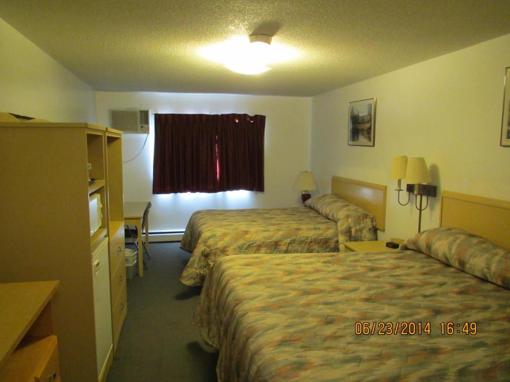 Postel nebo postele na pokoji v ubytování Lazy J Motel
