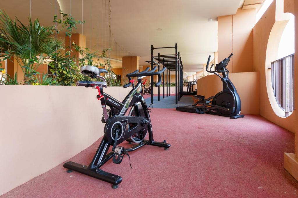 a gym with two treadmills and two exercise bikes at Teatinos Sky Garden II - CT 165 in Málaga