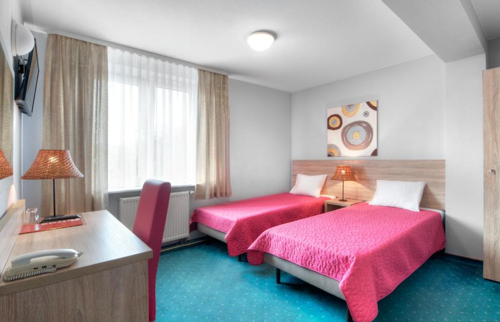 Posteľ alebo postele v izbe v ubytovaní Hotel Petrus