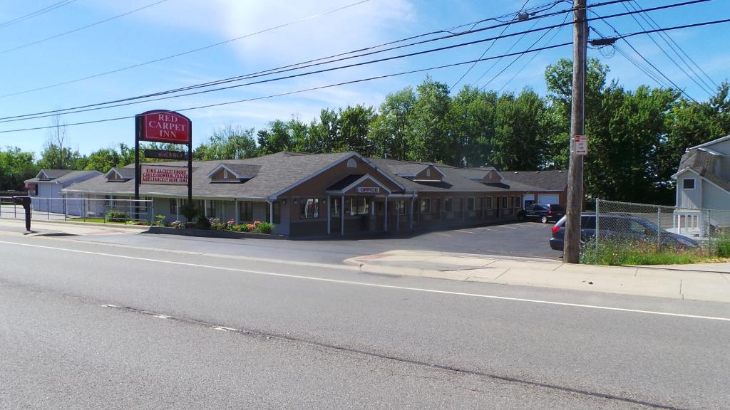 a building on the side of a street at Red Carpet Inn Orchard Park in Orchard Park