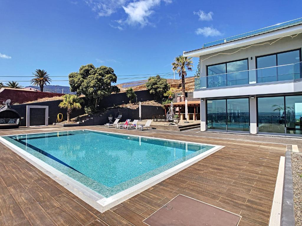 a swimming pool in front of a house at Villa Bahari by LovelyStay in Caniçal