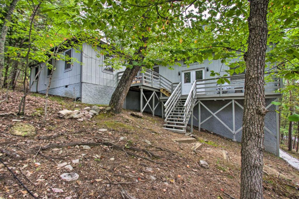 a house with a staircase in the woods at Vintage Massanutten Resort Villa with Deck! in McGaheysville