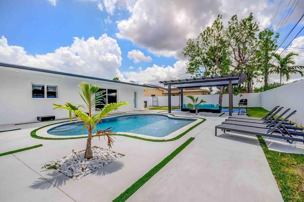 a villa with a swimming pool and a house at Miami Bliss - Blue Lagoon Haven L18 in Tamiami