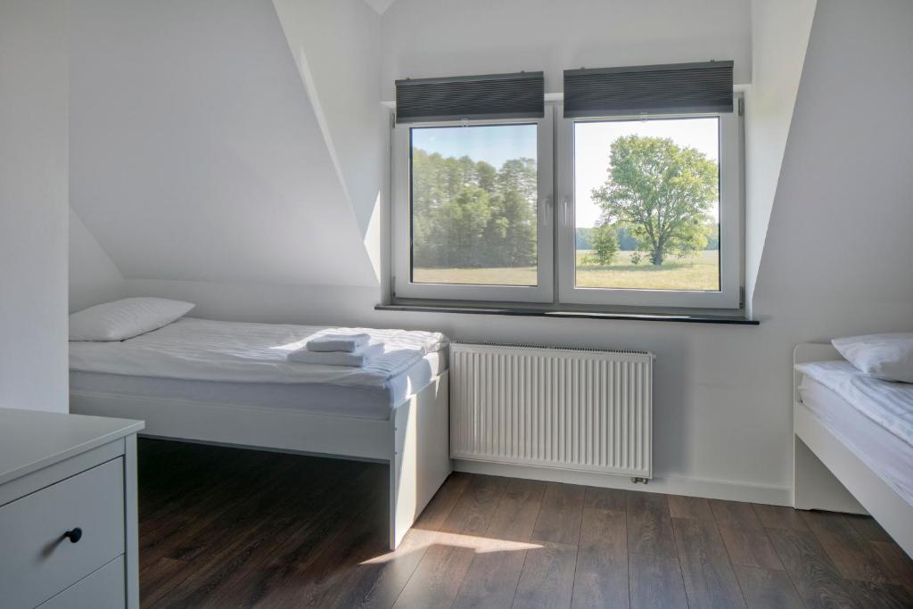 Postel nebo postele na pokoji v ubytování Apartamenty Zielona Lipka