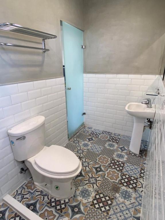 a bathroom with a toilet and a sink at Beauty Home Homestay in Hualien City